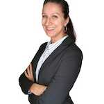 A confident professional woman smiling with her arms crossed.